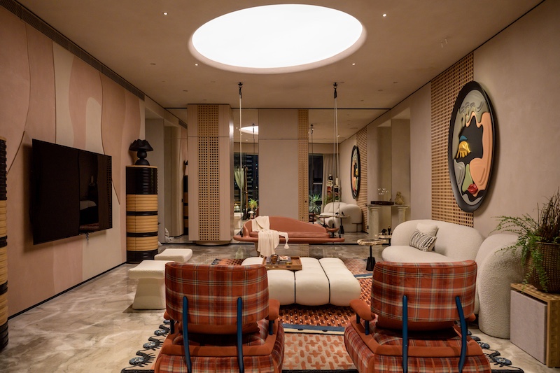 The living room features a skylight from Vibrant Technik armchairs from Cottons & Satins designed by DesignHex, boucle couches from Excella Experts and rugs designed by DesignHex produced by Square Knots. The centre table is from DesignHex and the lamps are by Harshita Jamthani Designs. (Image Credits: Wabi Sabi) 