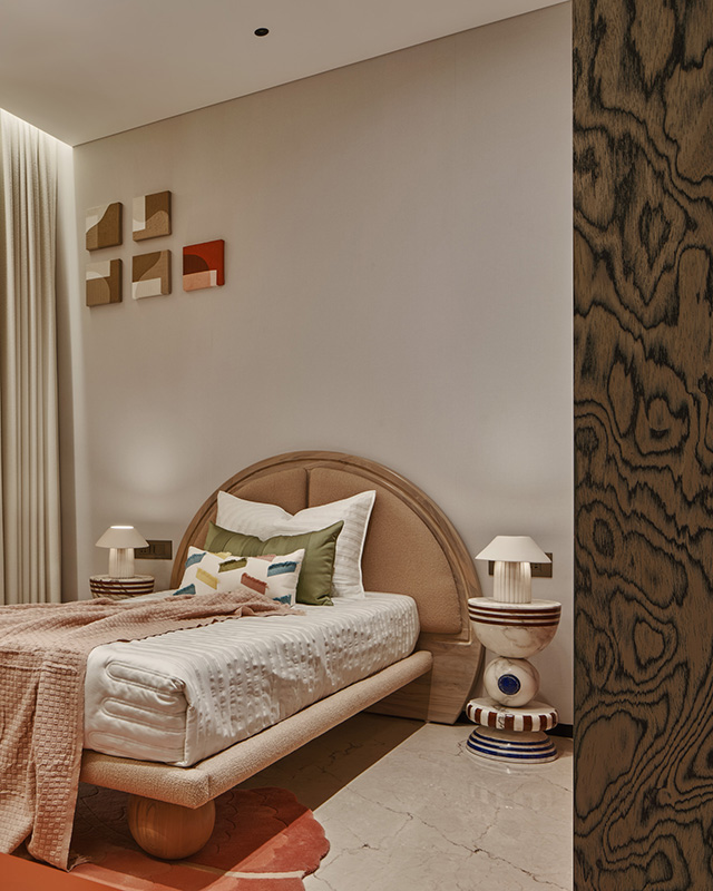 The kid's room features bright colours, curvilinear furniture and a marble totem that add a playful character to the space. (Image Credits: Courtesy of EON) 