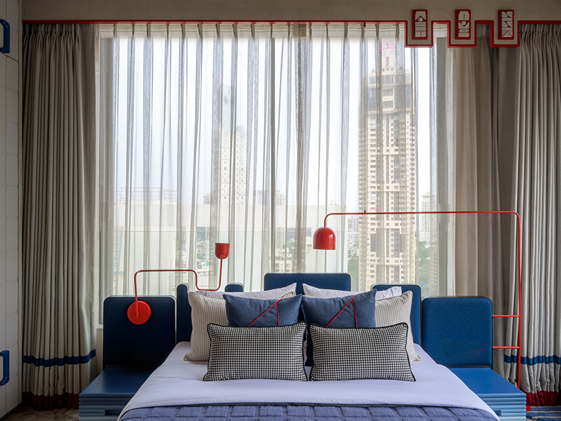 In Geome/Haus designed by DesignHex, sleek red lamps become the focal point of the room, drenched in a primary colour. (Image Credit: Wabi Sabi) 