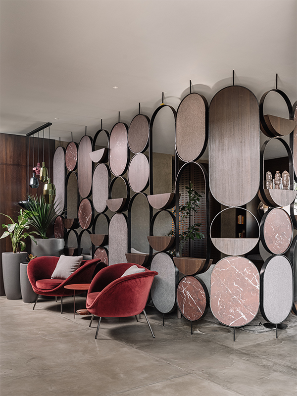 The Gio Ponti-designed maroon velvet-textured armchairs from Molteni are strikingly juxtaposed against the neutral palette in Casa Alleve, designed by Studio GreyBox and Neogenesis+Studi0261. (Image Credits: Ishita Sitwala) 