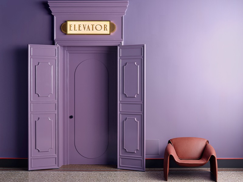 A cardinal-hued backdrop sets the stage for the Le Club armchair by Poliform. (Image Credits: Asian Paints)