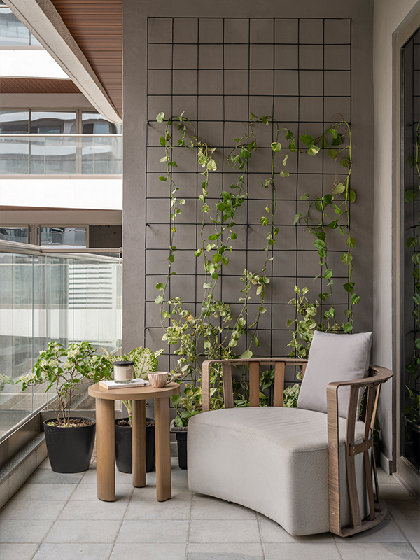 The outdoor deck is decorated with numerous planters, a wooden lounge chair and a coffee table, adding a rustic charm to the space. (Image Credit- Noaidwin Sttudio) 