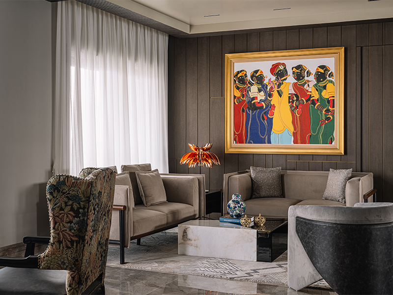 The red hues of the artworks in Apartment Footprints, designed by Asquare Designs, guide the inhabitants' eyes amidst the muted palette of the modern furnishings by Ochre at Home and carpets by Jaipur Rugs. (Image Credit: Yadnyesh Joshi) 
