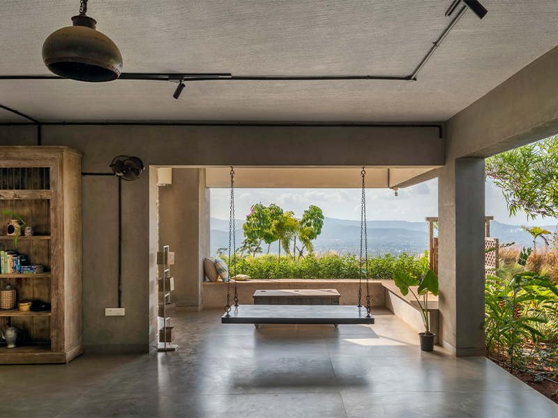 Framed by earthy, lime-washed walls, a suspended swing creates a tranquil nook overlooking the valley, while vintage wood accents add rustic charm.(Image Credits: Retiesh Ramaiyah)