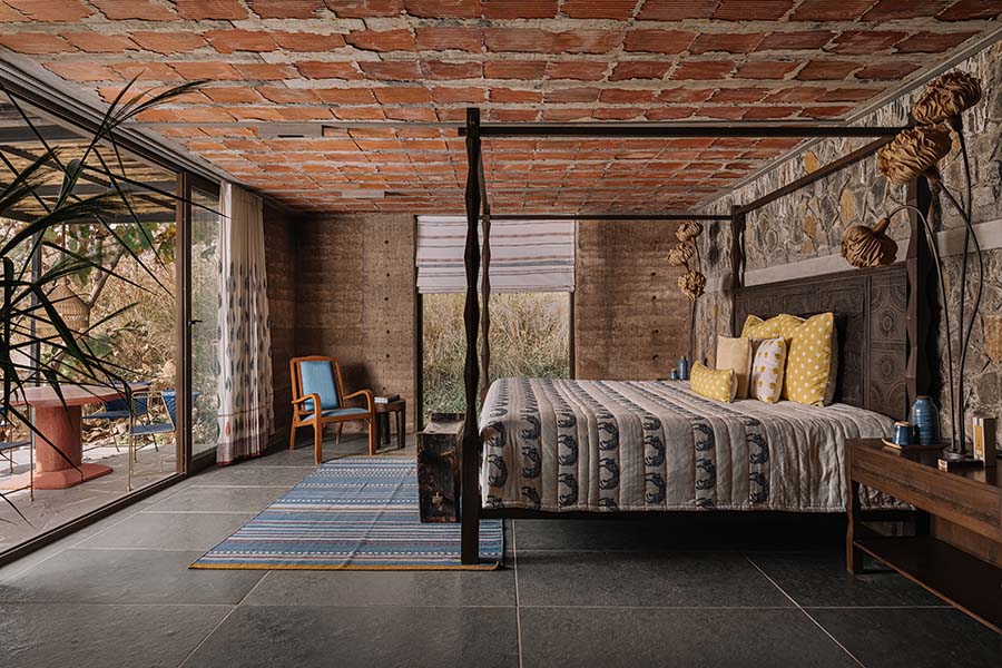 The warm and soothing interiors of the bedroom are coupled with natural-looking furniture and furnishings from This And That and lighting from Oorja. (Image Credit: Ishita Sitwala) 