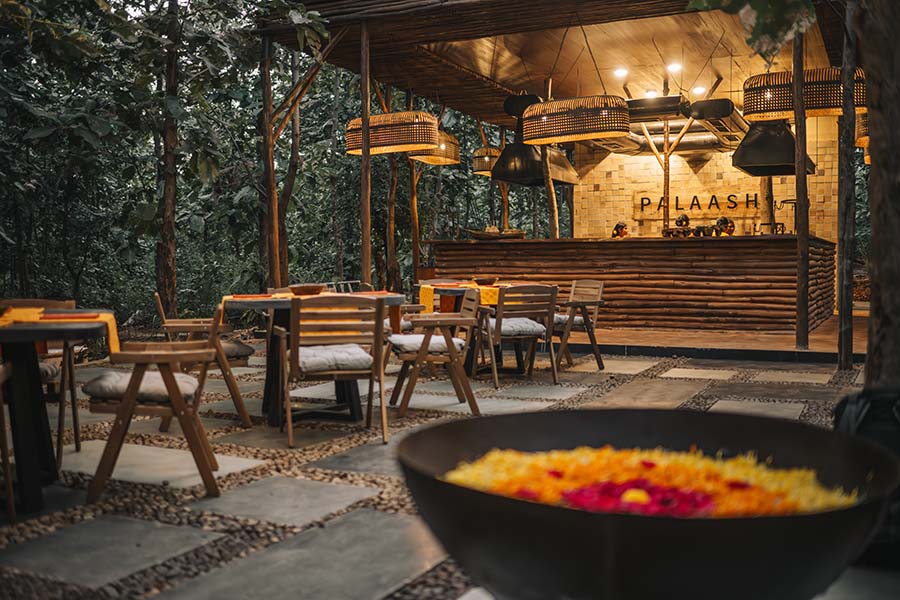 The in-house restaurant, Palaash, offers guests organic farm-to-table dining. The ambience is enhanced with antique lighting, while Artemicast stone tables and Ikea chairs complete the elegant dining setup. (Image Credit: Ravi Mistry) 