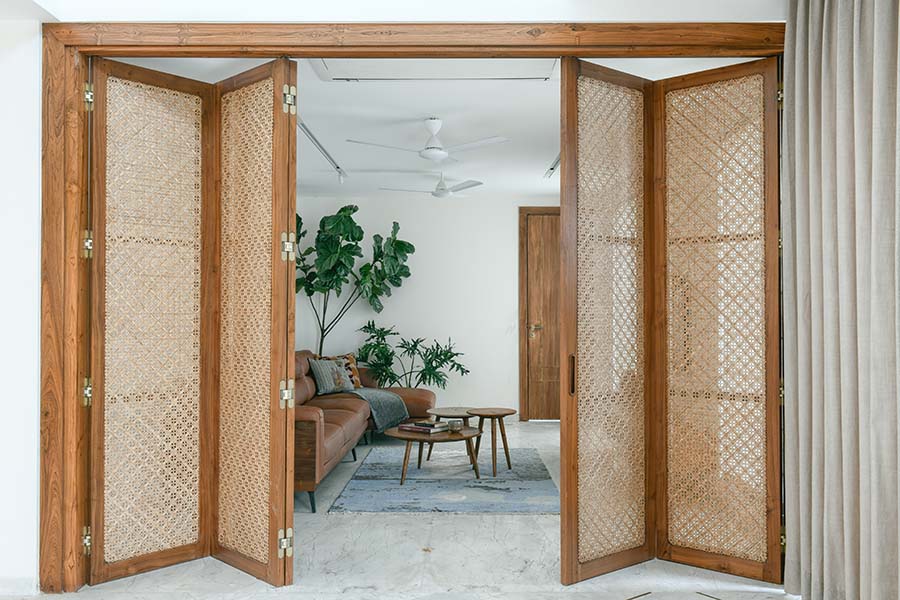 The siding partition separates the living and the drawing room in this Hyderabad home designed by Studio Davara (Image Credits: Monika Sathe) 