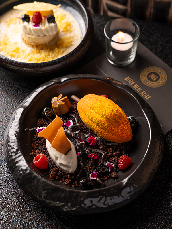 ‘Cacao Amazonica’ is a decadent ode to Peru—silky dark chocolate mousse layered over crunchy hazelnut praline, laced with a swirl of rum caramel, and paired with indulgent black truffle gelato atop rich chocolate soil. ( Image Credit: Inka)
