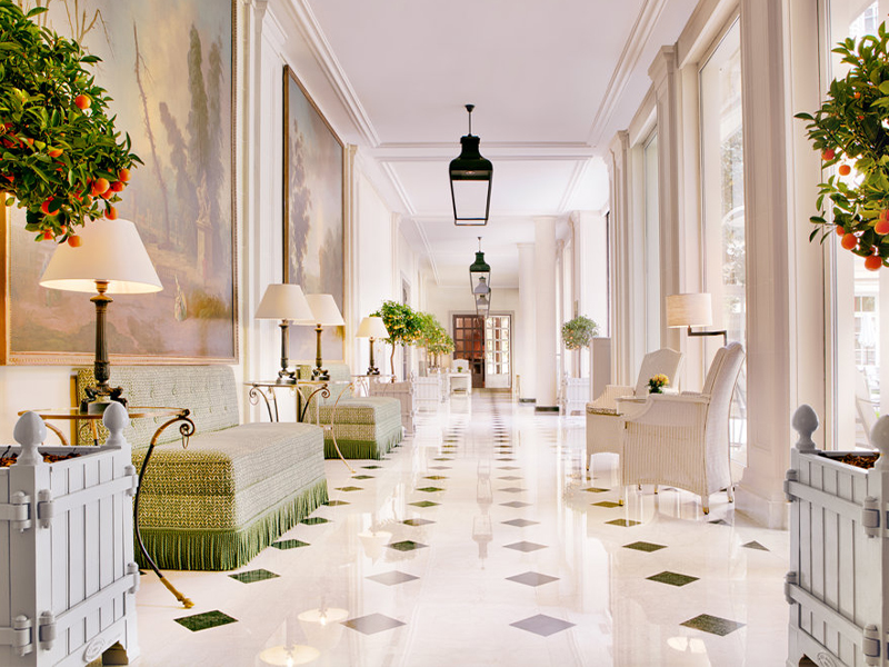 The graceful Colonnade, lined with fragrant calamondin orange trees, takes its name from the classical columns that define this serene and sun-dappled space. ( Image Credit: Le Bristol Paris - Oetker Collection) 
