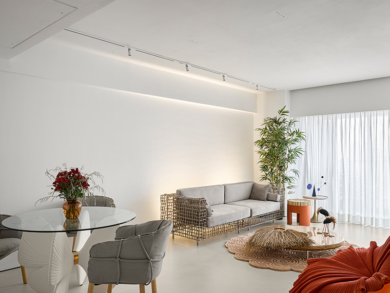The Gingko dining table with Parchment armchairs from Kenneth Cobonpue leads one to the living room and is punctuated with a pop of verdure. (Image Credits: Isha Shah) 