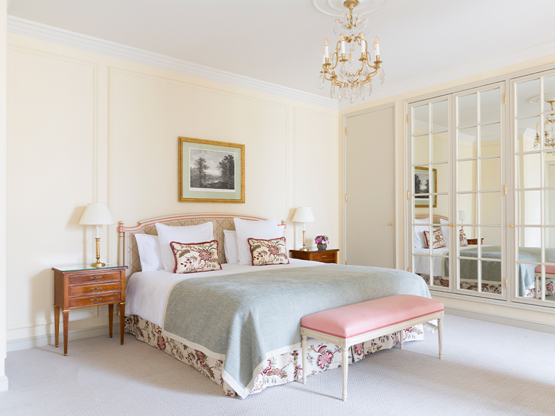The junior suite glows with natural light and soft pastel hues—jade, sky blue, coral—layered in rich textiles by Frey, Canovas, and Colefax & Fowler. ( Image Credit: Claire Cocano) 
