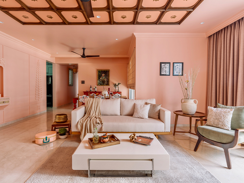 In Jade House by The Arch Studio, the subdued hues of the bespoke furniture and armchair from Lakkadhara and the White Vase & throw from Westside Home complement the peachy hues by Asian Paints in the living room. (Image Credits: Inclined Studio)
