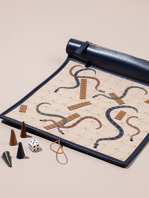 The Handcrafted Snakes & Ladders by The Leather Garden is easy to roll and well-suited to play indoors while it's too hot outside. Price: ₹ 5900 (Image Credits: Vindhya Singh)