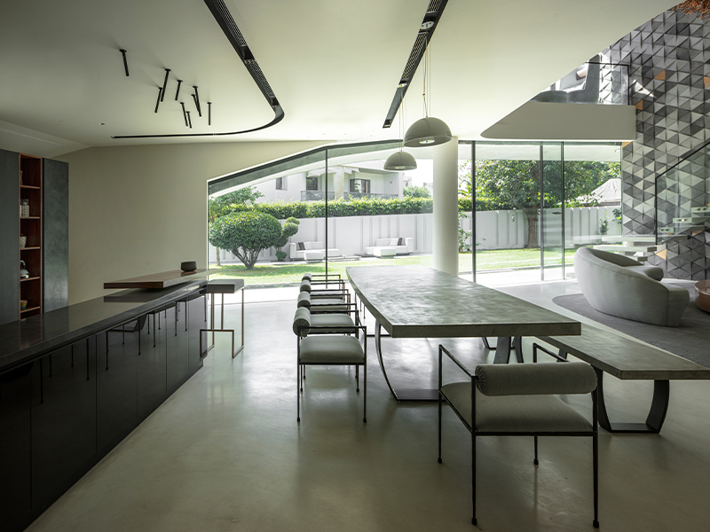 The double-height living space spills into the dining and open kitchen space, which combines the two floors into one publicly accessible zone. (Image Credit: Niveditaa Gupta)
