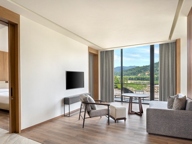 The living room of the executive suite looks out to the river. (Image Credits: Jim Corbett Marriott & Spa)