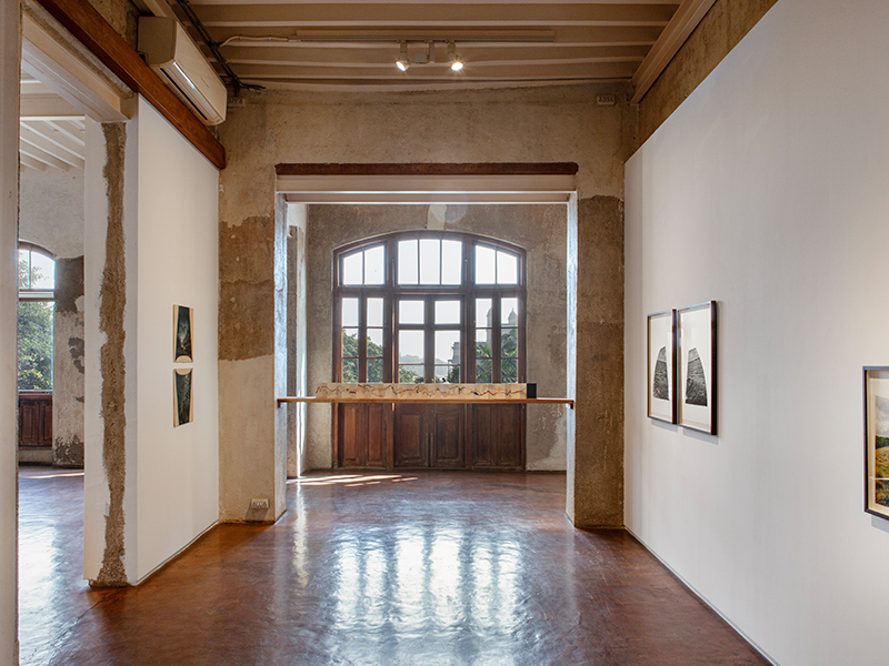 The rustic interiors of Jhaveri Contemporary with the installation by Muhanned Cader, 'Island in the Sky.' (Image Credits: Courtesy of Jhaveri Contemporary) 