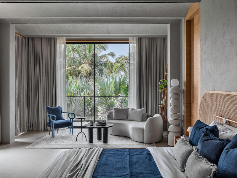 There are six bedrooms with distinct designs but a similar approach to capitalising on the views around the house. Furniture by Ravi Vazirani, and lighting by Hybec and Harshita Jhamtani dot up this bedroom on the top floor. (Image Credits: PHX India)