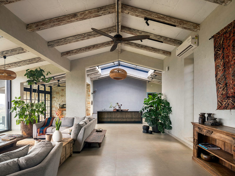 The weathered wood rafter paired with muted-toned walls by Asian Paints and colossal windows blur the boundaries between nature and the home. (Image Credits: Retiesh Ramaiyah)
