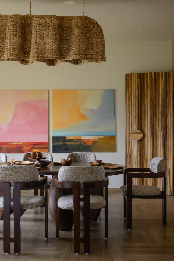 With its warm, raw tactility, bamboo flows seamlessly into the earthy palette of this dining space. Locally made abstract artworks introduce a vibrant layer of maximalism. The chairs are faithful reproductions of the iconic Tobia Scarpa design, crafted by local artisans. The raw-edge crockery spread on the dining table is from Bali, Indonesia (Image Credits: Ashutosh Agarwal)

