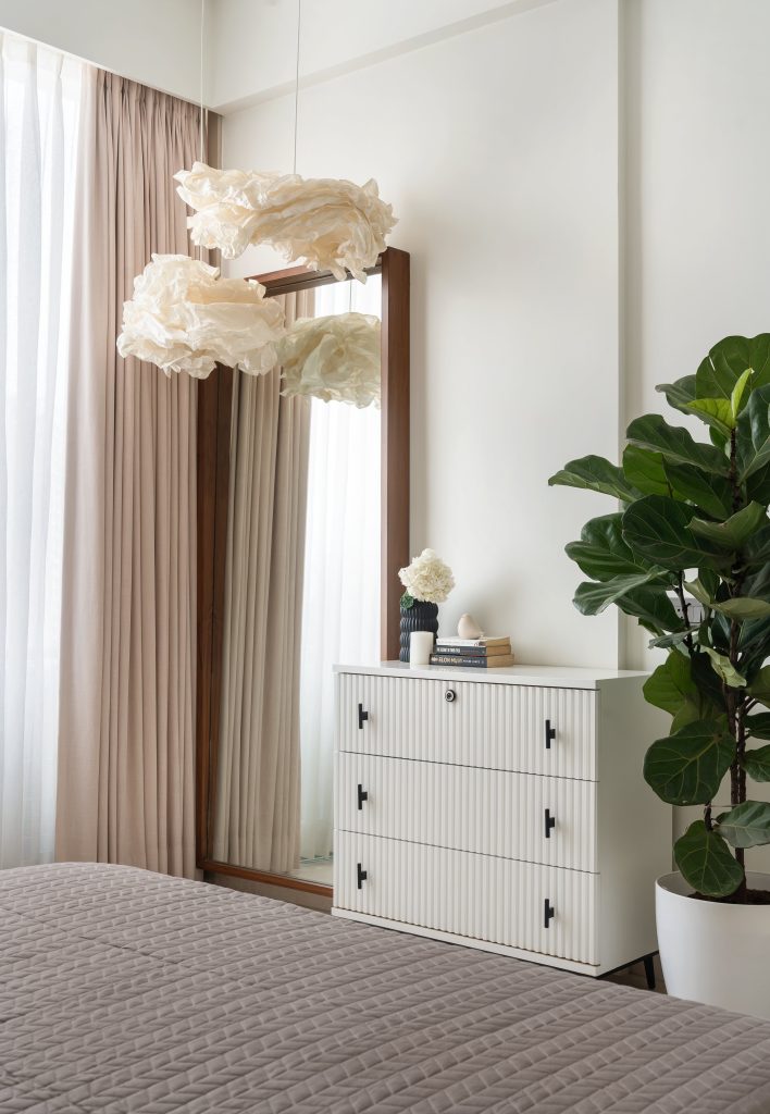 Floating like clouds above the fluted cabinet, paper lamps from IKEA bring an ethereal softness to the daughter’s clean-lined dressing corner. (Image Credits: Biju Gopal) 