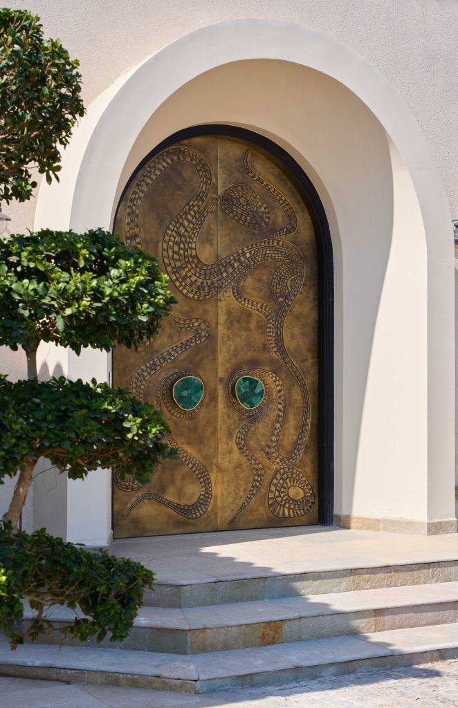 The villa opens with a luminous, emerald-accented door by Aluminr—setting the tone for the layered design within. (Image Credits: The Matter Studio)