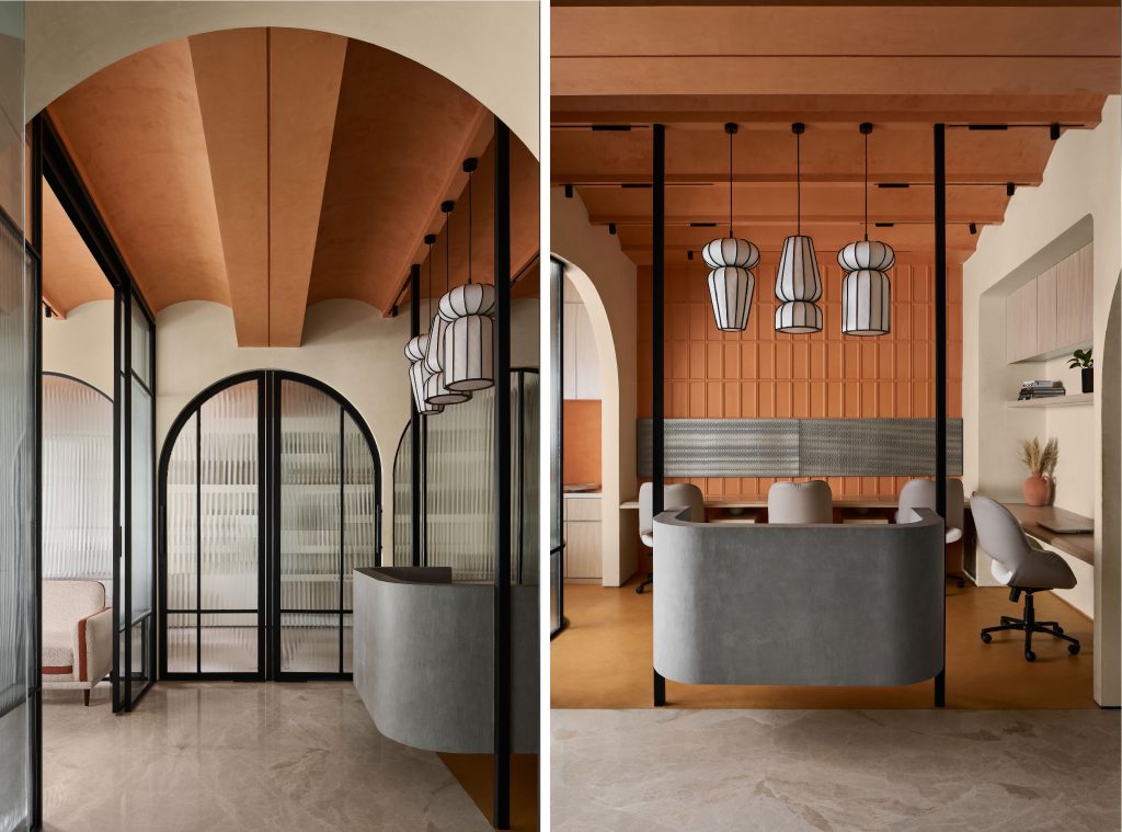 On the left is the meeting lounge, with a suspended solid reception table that garners attention by gently nudging itself ahead into the central passage. Right: An elegant workstation with lights picked from Length Breadth Height, and ergonomic chairs from Wabi-Sabi. (Image Credits: Yadnyesh Joshi) 