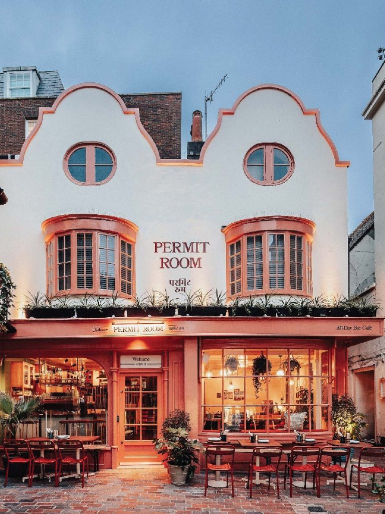 Permit Room on Portobello Road is housed in a storied 19th-century Irish hotel that later became a West Indian pub-turned-distillery — a layered history that still lingers in its facade. Image Credit: (Permit Room Lodgings).