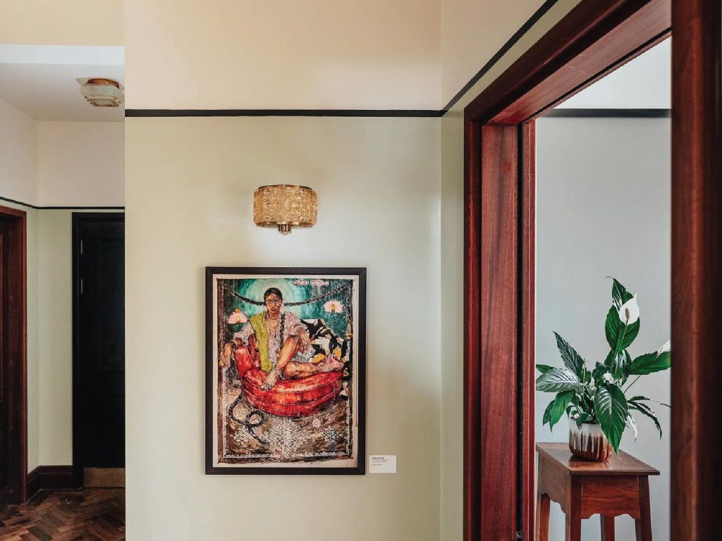 Nibha Akireddy’s striking self-portrait, Jadala Rajyam (Rule of Braids), hangs in the corridor. The piece pulses with power, drama, and an unapologetic embrace of identity. Image Credit: (Permit Room Lodgings)