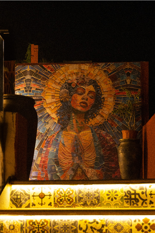 The mosaic mural of the Moon Goddess watches over the space, weaving mythology into every corner with colour, grace, and quiet power. (Image Credits: Courtesy of Mamma Killa)
