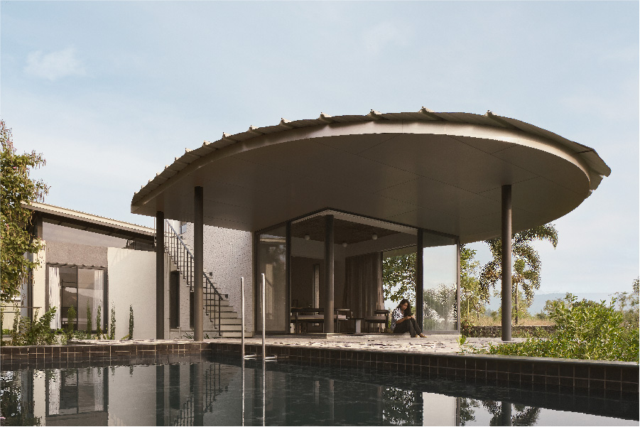 A shimmering, mirror-like plunge pool clad with jet black granite and sumptuously dark tiles on the inside serves to reflect the prairie-style Pavilion House. (Image Credit: Yadnyesh Joshi) 