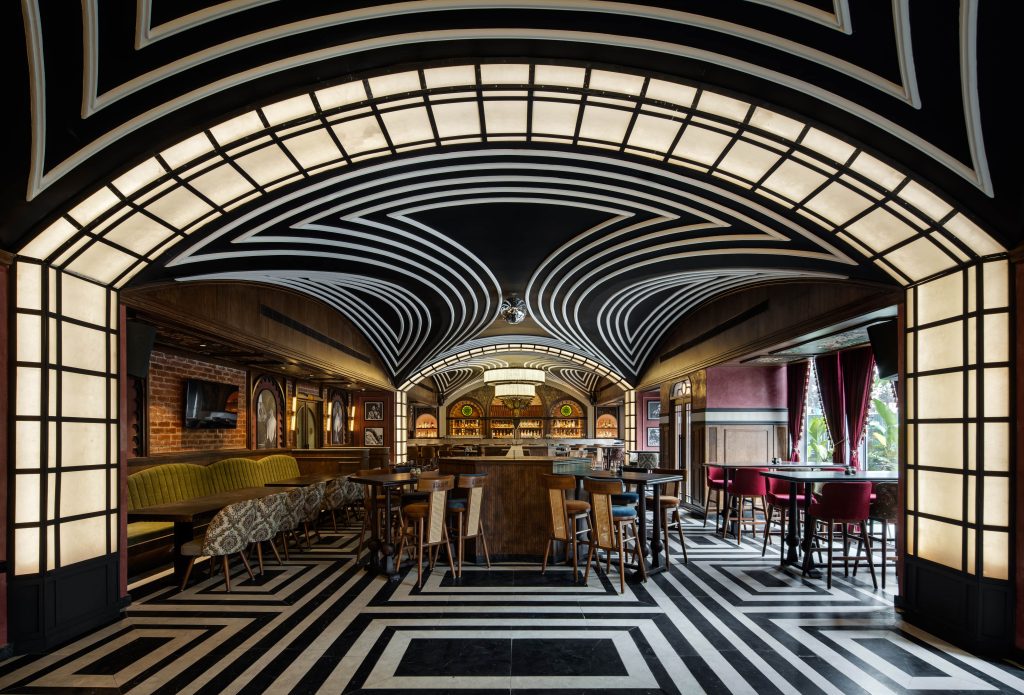 This classic pub in Bangalore has a striking black-and-white checkerboard floor that continues onto the ceiling, creating a theatrical sense of symmetry and rhythm. (Image credits: Shamanth Patil)
