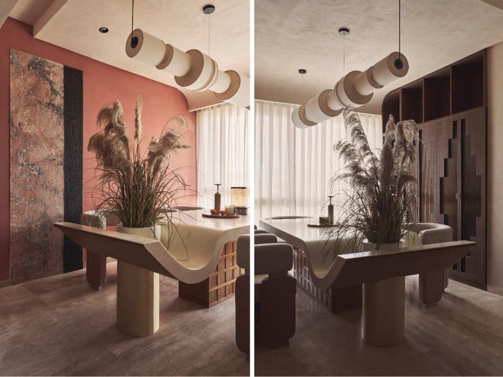 Left: In the dining area, stone panels from Grava slice through the coral wall, inducing a textural counterpoint. Overhead, a cylindrical fabric light from Thakur Lamps completes the mise en scène. Right: To the side, the crockery unit flaunts zigzagging wooden shutters that playfully offset the room’s curves. (Image Credits: Yadnyesh Joshi)
