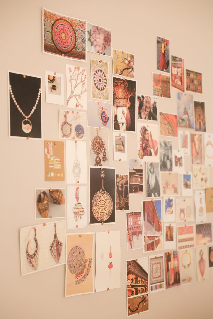 A wall-mounted moodboard display reveals jewel sketches and patterns in progress, alongside a 19-piece capsule reimagining balis, jhumkis, and yard chains with a sharp, architectural sensibility. (Image Courtesy: Zoya Jewels)

