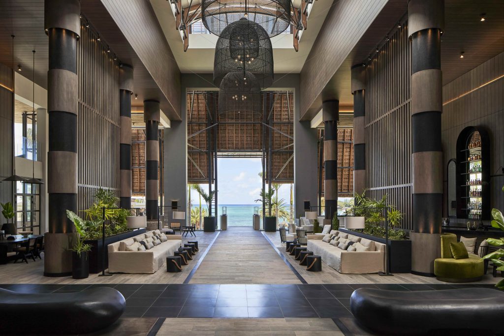 The lobby lounge is awash in taupe—a warm, inviting, and versatile signature palette that adds depth without overpowering the space, subtly juxtaposed against the natural beach surroundings. Image Credit: (Tom Fallon) 
