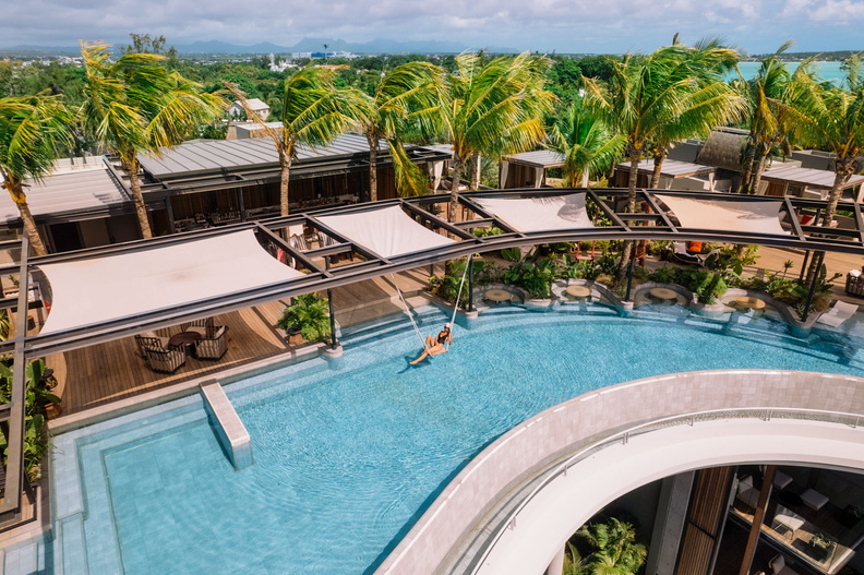 Biosu, the adults-only infinity lounge, features in-water dining and playful swings—perfect for all-day lounging or sipping a sundowner while watching the spectacular Mauritian sunset. (Image Credit: Lizzy Cole & Jerome Poirier)
