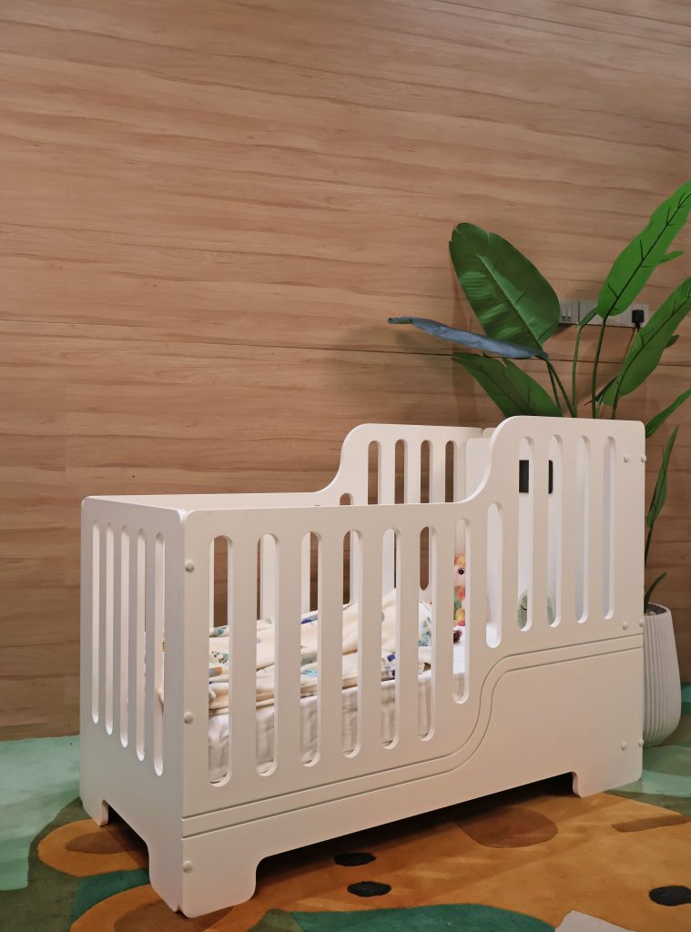 This baby cot fuses safety, technology, and design into a cocoon of comfort and care. (Image Credits: Waddle & Roo) 