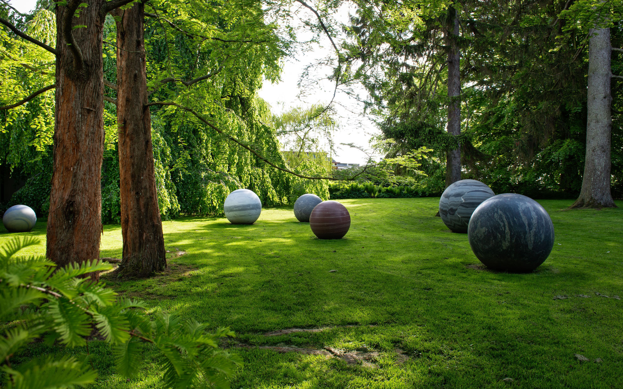 Artist Alicja Kwade created the eight large, perfectly rounded stone globes for the Moon exhibition in 2018, and the installation has remained on display ever since, a part of the sculptural park. (Image Credit: Kim Hansen)