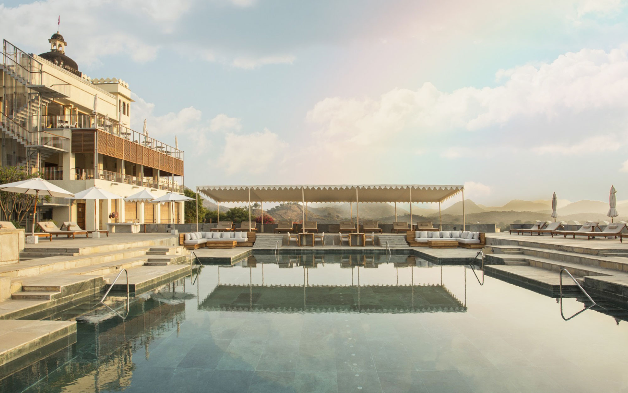 A sculptural metal staircase anchors the three-storey public wing, seamlessly linking the gym, restaurant and rooftop lounge by the pool, linking the zones. (Image Credits: Ravinder Solanki)