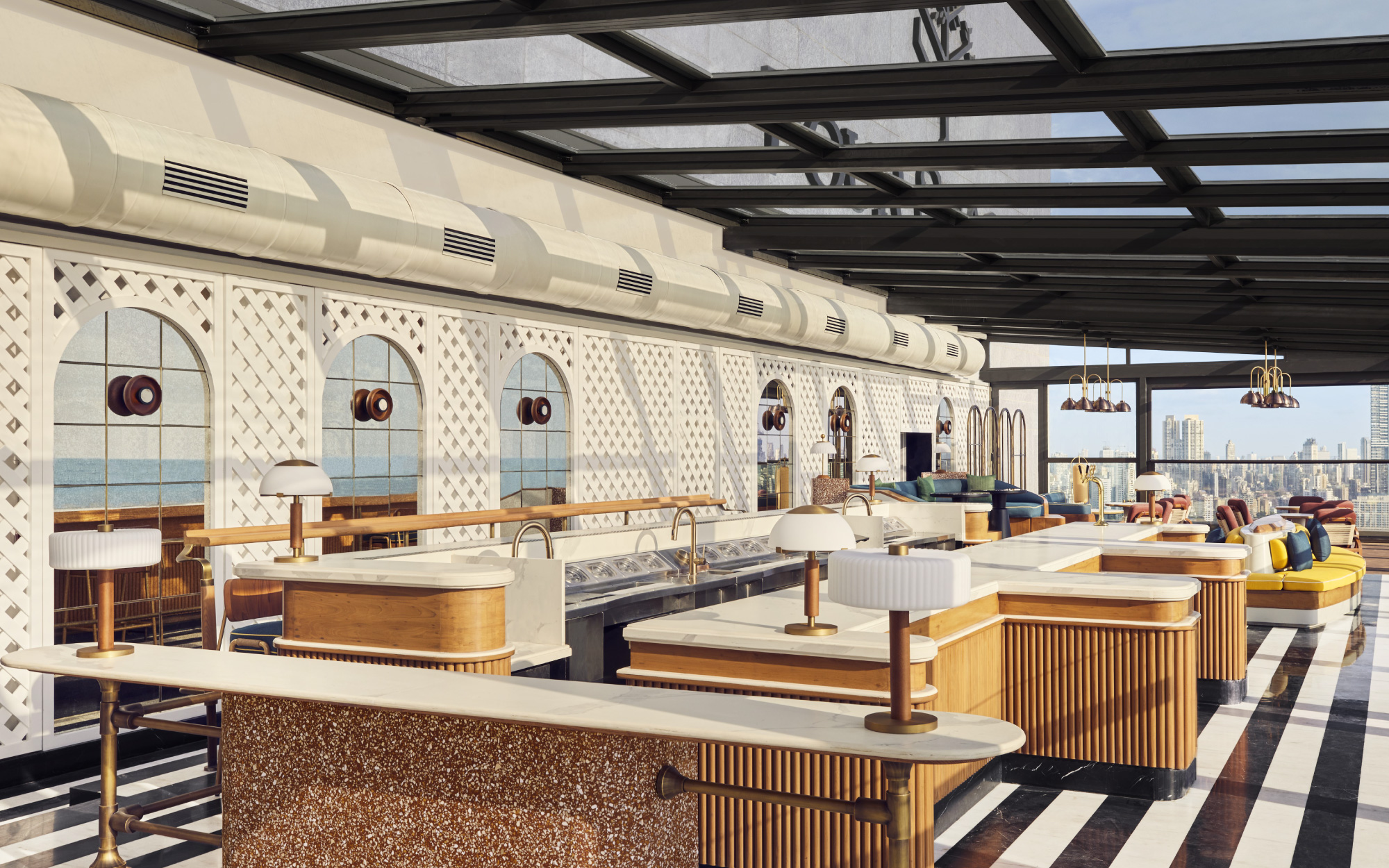 For a chic, open-air experience, ‘AER’ commands the rooftop with its retractable Wimbledon-style roof, perfect for cocktails against the Mumbai skyline. (Image Credit: Four Seasons Mumbai)