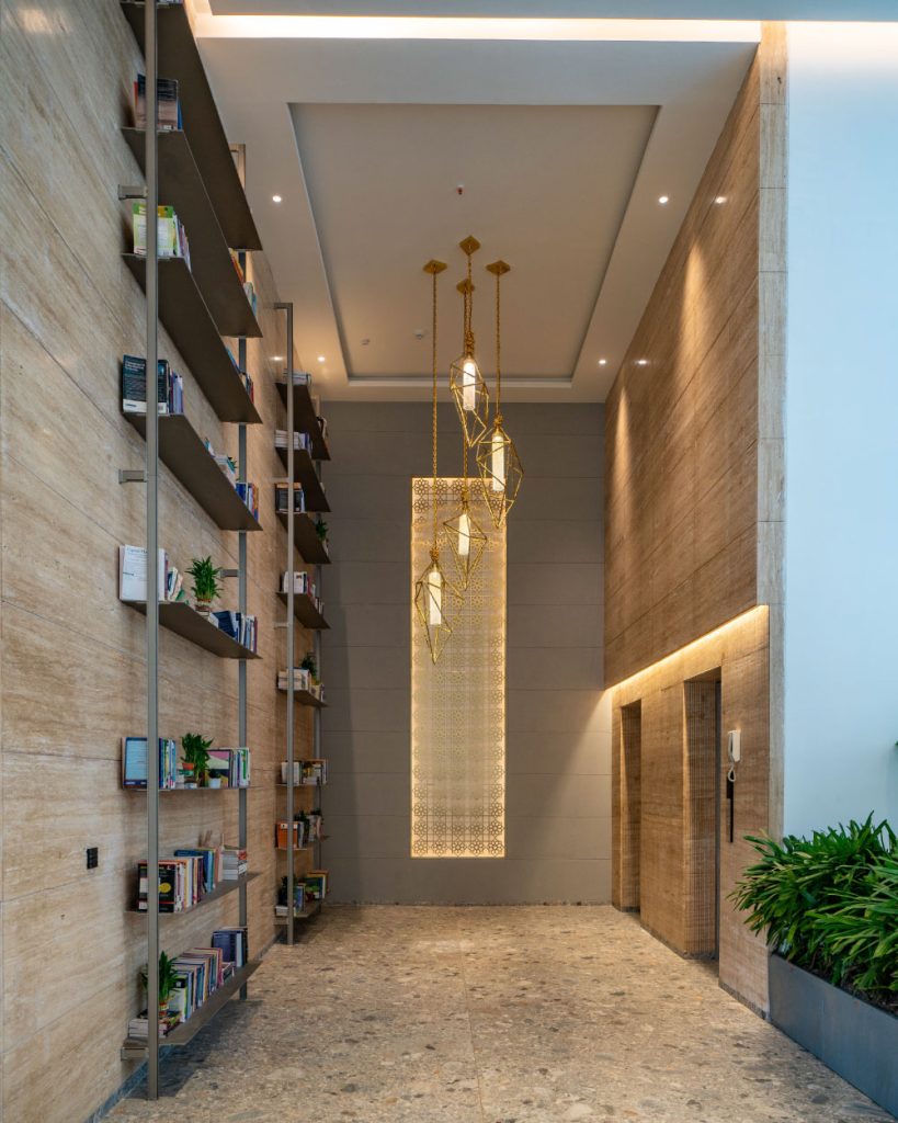 The elevator area with a pendant light and a curated reading nook sets the tone for the showflats. (Image Credits: The World Experience Centre)