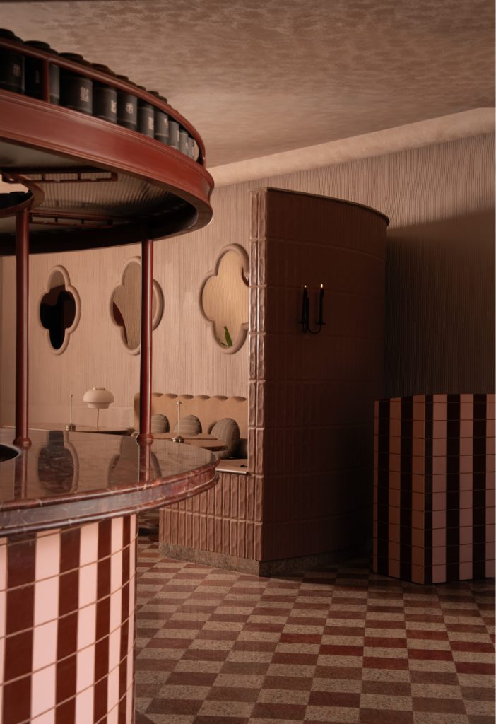 The monolithic tiled bar, adorned in custom-glazed ceramic tiles, curves across the room to become the project’s sculptural anchor. (Image Credits: Avesh Gaur)