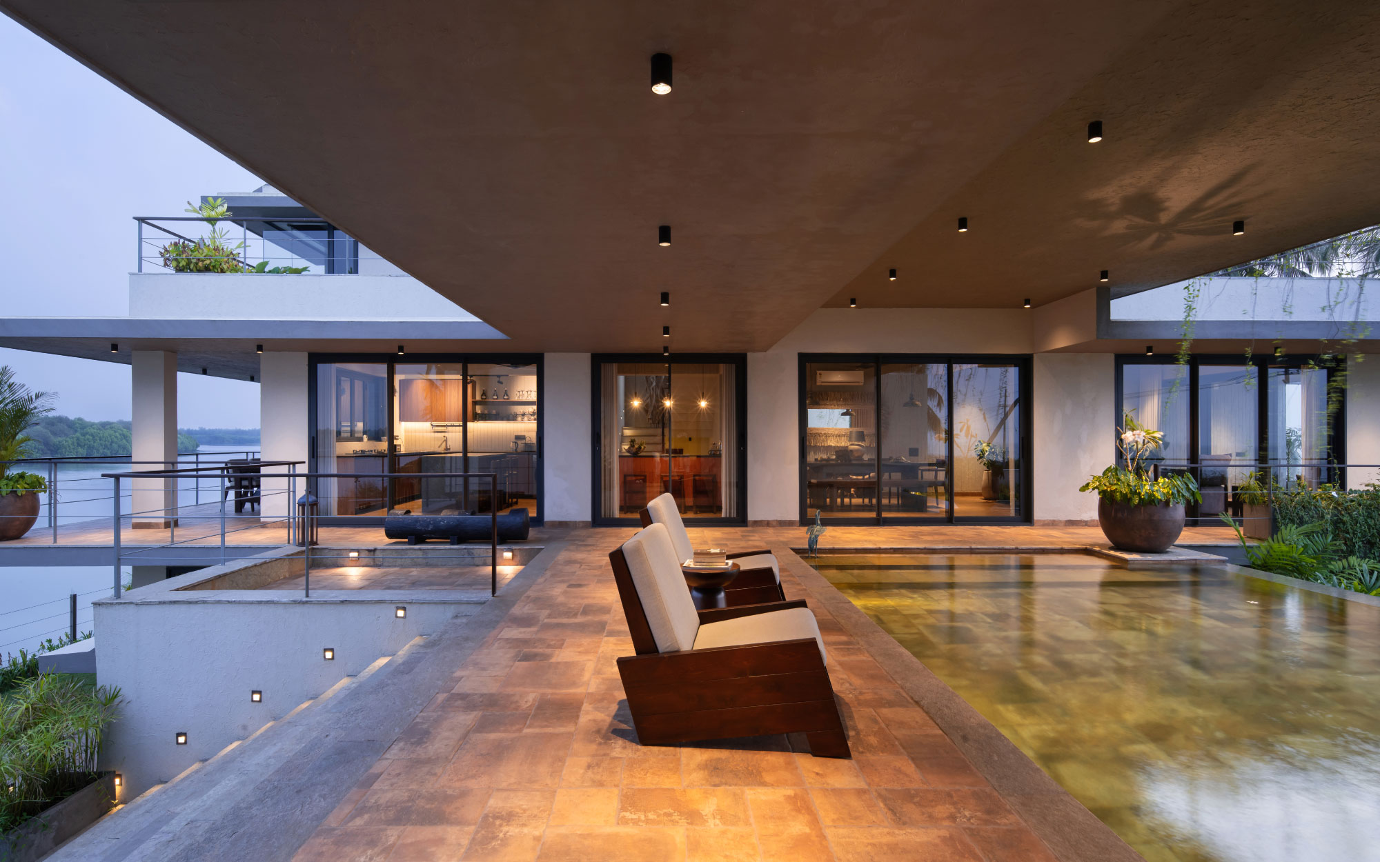 The deck serves as the anchor that seamlessly ties the two blocks of the home together. The lighting is from Purple Turtles, Furniture and Furnishings from Creatomy and Petals, Beruru, Chairs & Company and Cane Boutique. (Image Credits: Justin Sebastian, Athul Niranjan).