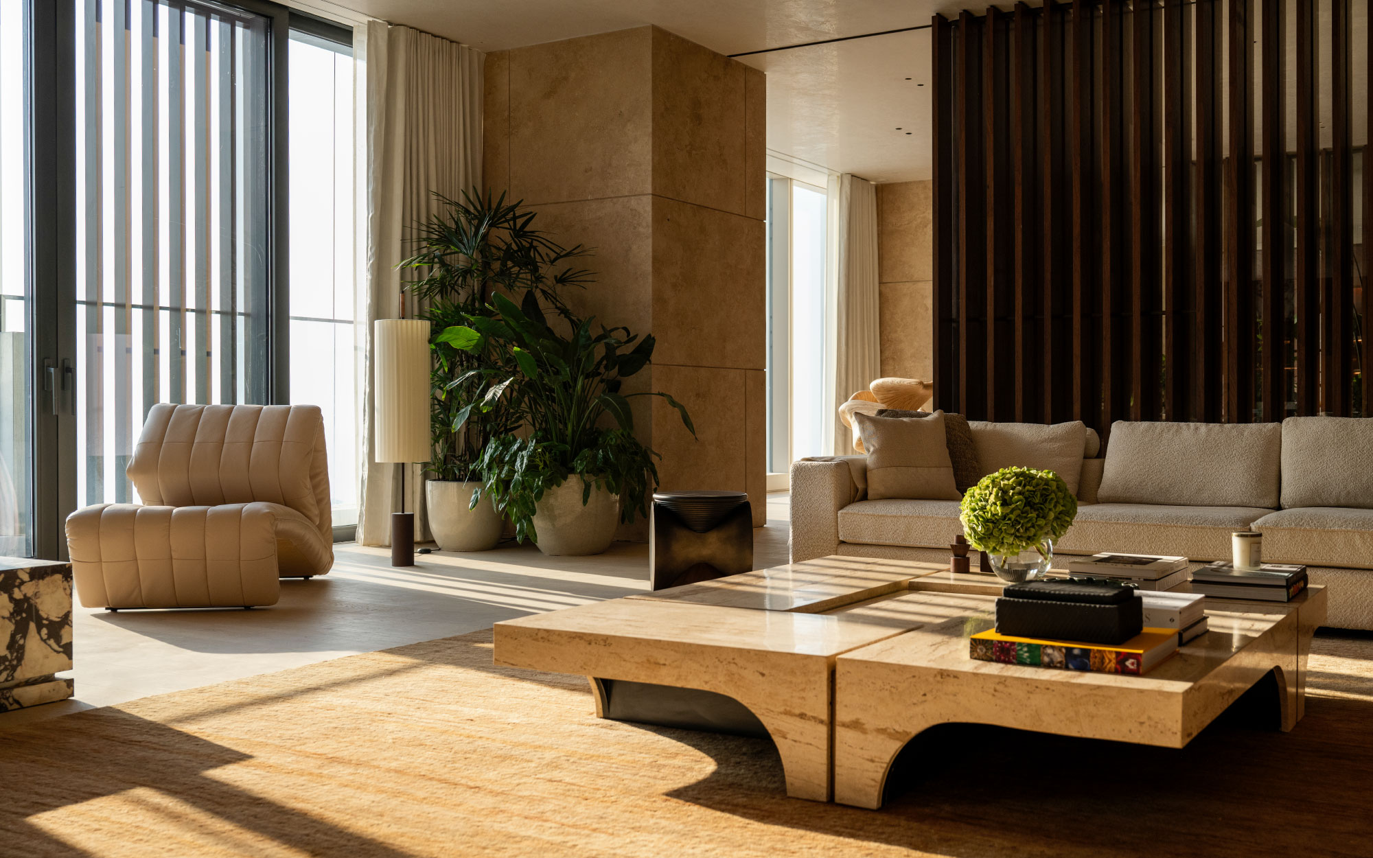 The formal living room draws from a palette of marble used as an accent material, be it for the custom-made fireplace, centre tables or countertops. (Image Credit: Patricia Goijens)