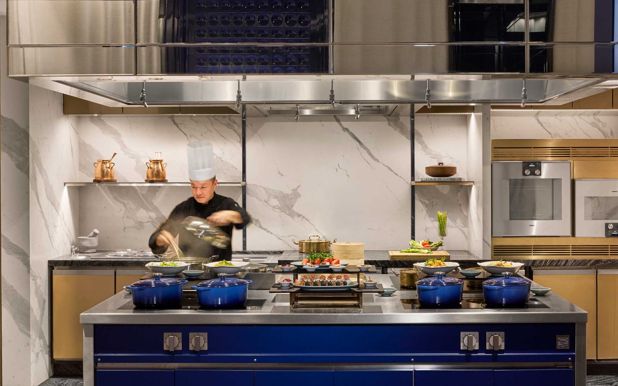 A live kitchen brings the growing trend of experiential hospitality to life, allowing guests to engage directly with culinary creation through live demonstration spaces. (Image Credits: Four Seasons Mumbai)