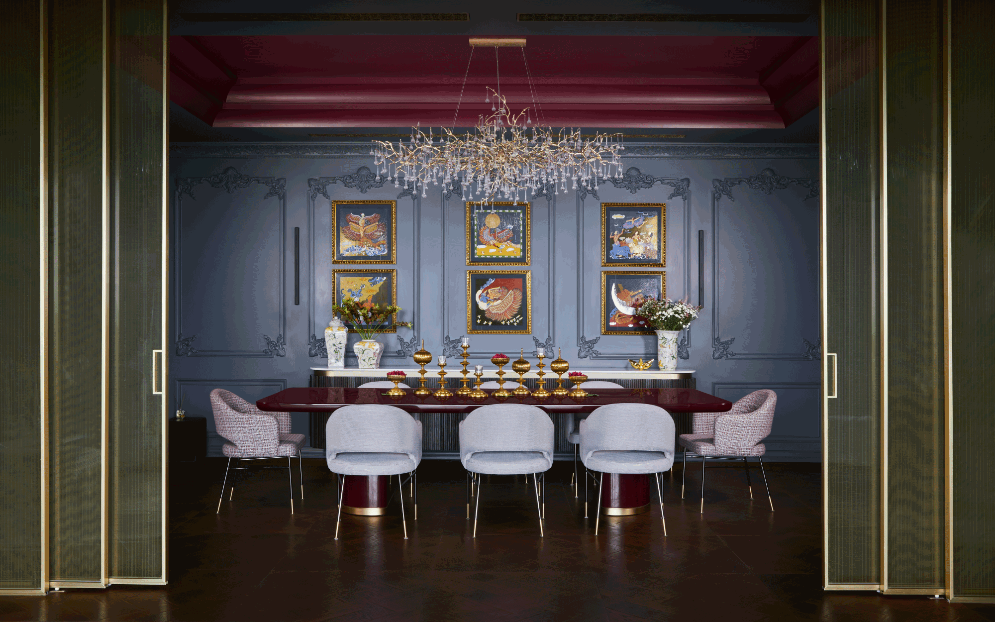 In the dining area, a Flos fixture and a chandelier by Serip illuminate the setting, while a dining table, chairs, and credenza from DemuroDas are complemented by a dessert console by Rooshad Shroff, with artwork by Seema Kohli adding a striking focal point. (Image Credits: Ashish Sahi)