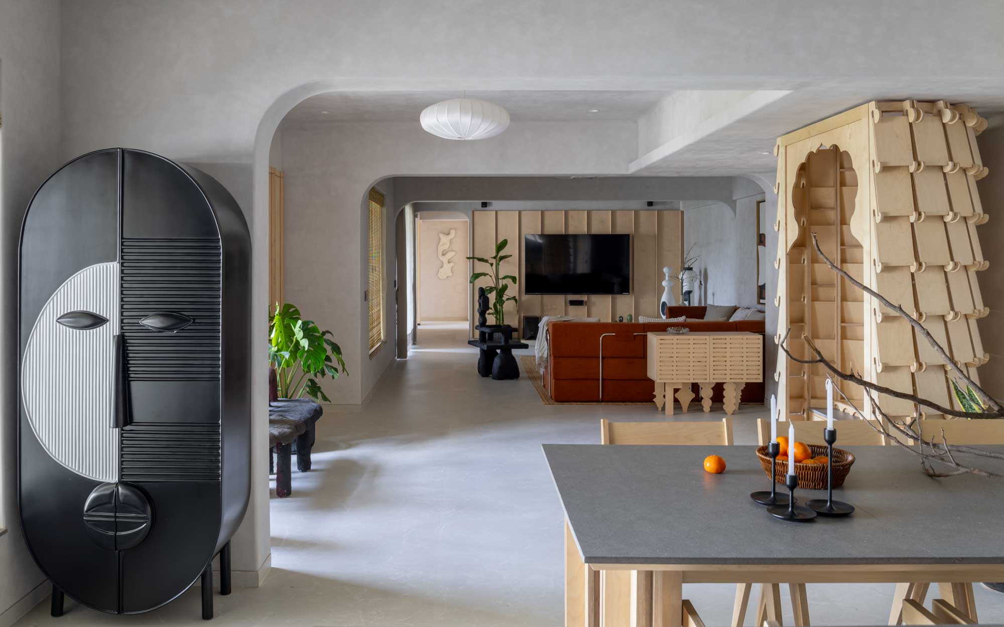 The living area leads to the open-plan kitchen and dining area. The flooring from Simpolo Tiles and Bathware and ceiling work from Gyproc give the space a pared-back look. The lighting fixtures are from Litomatic. (Image Credits: Viveekajeet Purohit)