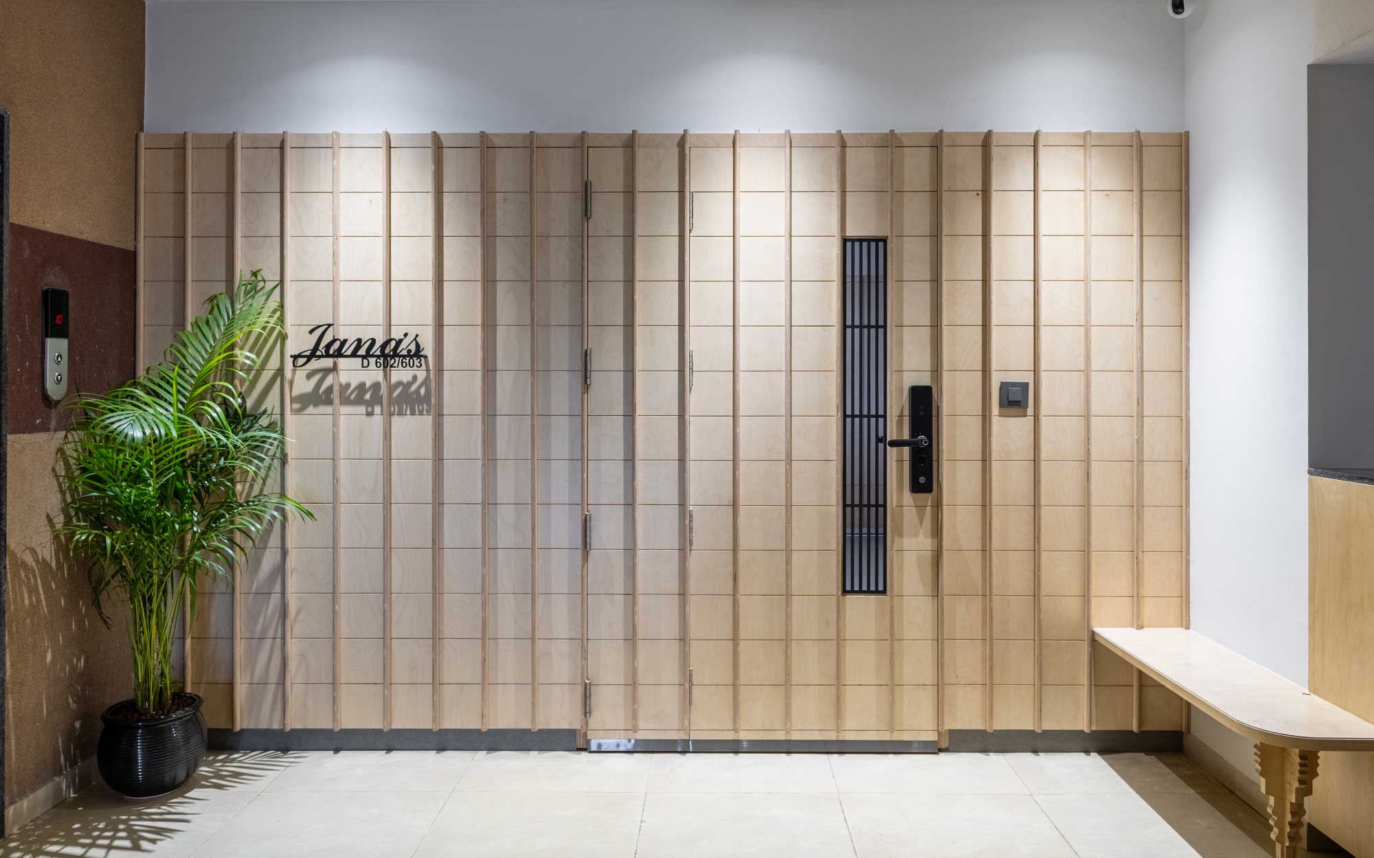 The entrance door is clad in Birch with a quirky bench serving as a deliberate pause. (Image Credits: Viveekajeet Purohit)