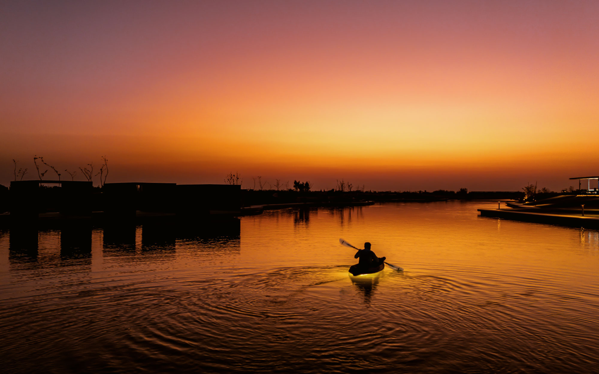 The 72,000 sq. yd. man-made lake meticulously plans the entire site, allowing a collection of 99 villas. (Image Credits: Suryam Developers) 